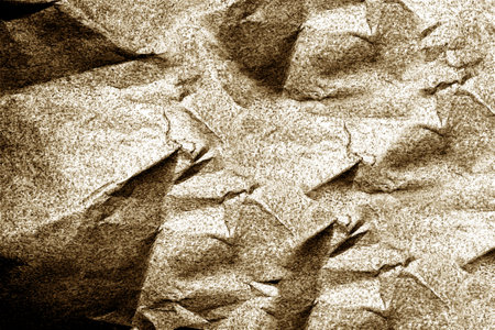 Crumpled paper creates textured background with light brown huesの写真素材
