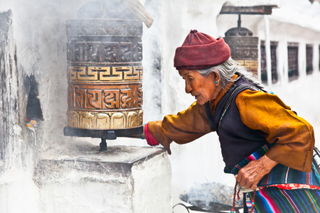 KATHMANDU, NEPAL - MAY 18: Unidentified woman go around one of the most significant relics in the world Bouddanath Stupa praying wheels May 18, 2013 in Kathmandu, Nepal.のeditorial素材