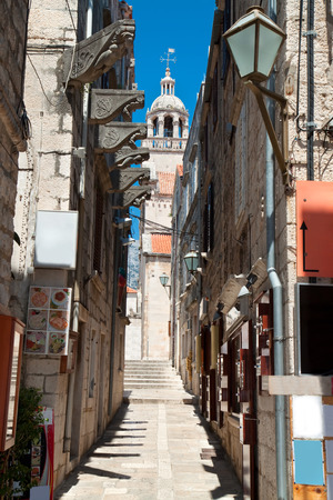 Typical narrow street in old medieval town Korcula by suny day. Croatia, Dalmatia region, Europe.の写真素材
