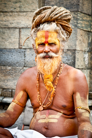 KATHMANDU, NEPAL - MAY 18: Shaiva sadhu seeks alms on the Pashupatinath Temple  on May 18, 2013 in Kathmandu, Nepalのeditorial素材