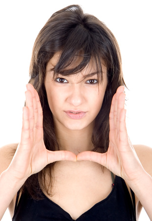 Beautiful young lady showing a sign with handsの写真素材