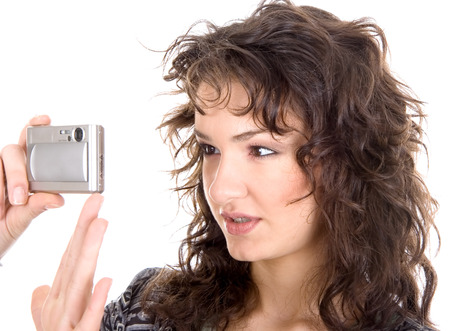 Standing young woman holding a cameraの写真素材