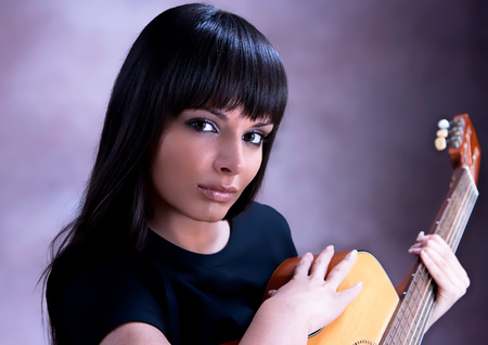 Beautiful Woman are Playing Guitar, studio shotの写真素材