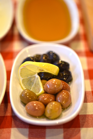 olive plate with a slice of lemonの写真素材