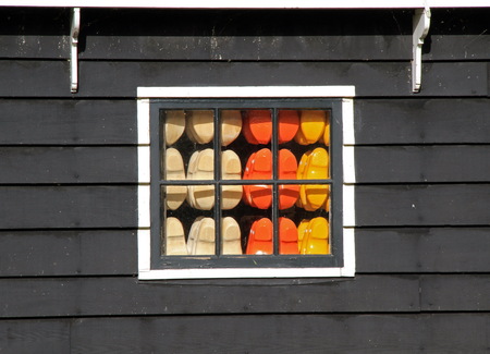 colourful dutch wooden clocks in windowの写真素材