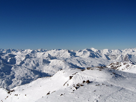 the horizon filled with snow-capped mountainsの写真素材