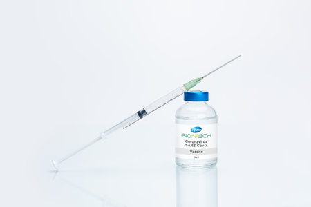 Mainz, Germany -12.12.2020: Pfizer Inc. and BioNTech Covid-19 vaccine concept. Vaccination and therapy against the corinavirus. Blurred logos printed on white paper.のeditorial素材
