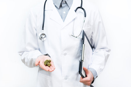 Doctor with medical cannabidiol CBD cannabis marijuana with white isolated background. Alternative, natural, legal medicine for pain. Legal medical marijuana for healthcare.の写真素材