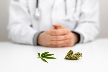 Doctor with medical cannabidiol CBD cannabis on table with white background. Alternative, natural, legal medicine for pain. Legal medical marijuana for healthcare.の写真素材