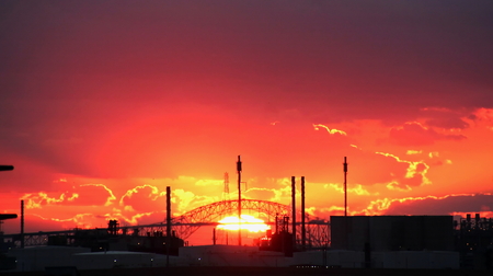Colorful red sunrise, daylight, at the port of Corpus Christi, USA Wiev of port facilities and ships in the rays of the waning sun.の写真素材