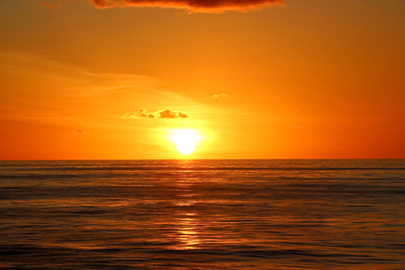 Sunset in the Pacific Ocean. Different types of sunset from the side of the ship while driving and anchoring at the port. Riot of colors of the ocean, clouds and sun.の写真素材