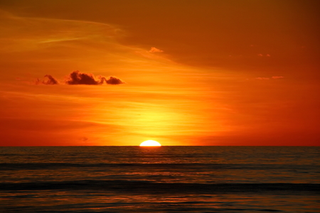 Sunset in the Pacific Ocean. Different types of sunset from the side of the ship while driving and anchoring at the port. Riot of colors of the ocean, clouds and sun.の写真素材