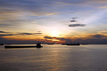 Sunset in the Pacific Ocean. Different types of sunset from the side of the ship while driving and anchoring at the port. Riot of colors of the ocean, clouds and sun.の写真素材
