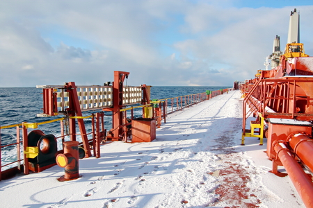 Ice of the ship and ship structures after sailing in frosty weather. Ice patterns and icicles, the play of light, ice and sun.の写真素材