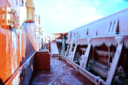 Ice of the ship and ship structures after sailing in frosty weather. Ice patterns and icicles, the play of light, ice and sun.の写真素材