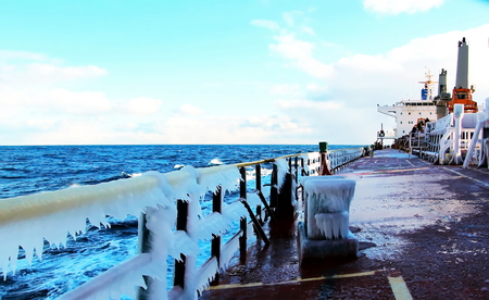 Ice of the ship and ship structures after sailing in frosty weather. Ice patterns and icicles, the play of light, ice and sun.の写真素材