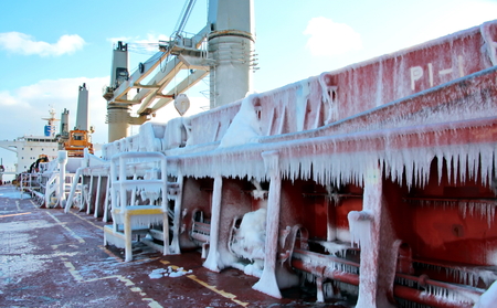 Ice of the ship and ship structures after sailing in frosty weather. Ice patterns and icicles, the play of light, ice and sun.の写真素材