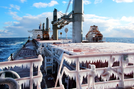 Ice of the ship and ship structures after sailing in frosty weather. Ice patterns and icicles, the play of light, ice and sun.の写真素材