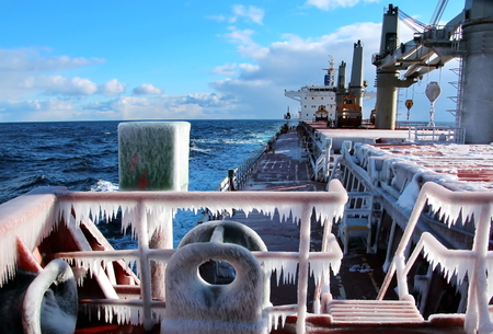 Ice of the ship and ship structures after sailing in frosty weather. Ice patterns and icicles, the play of light, ice and sun.の写真素材