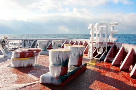 Ice of the ship and ship structures after sailing in frosty weather. Ice patterns and icicles, the play of light, ice and sun.の写真素材