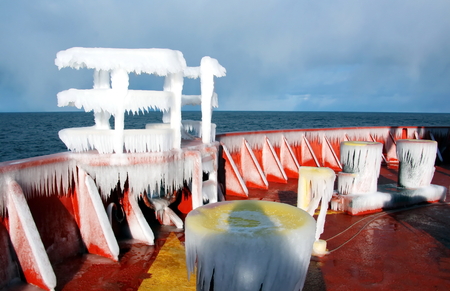 Ice of the ship and ship structures after sailing in frosty weather. Ice patterns and icicles, the play of light, ice and sun.の写真素材
