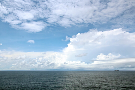 Seascapes. Various kinds of colorful blue sky, sun, clouds and open spaces of the world ocean. View from the side of the sea ship while moving and in the port at anchor.の写真素材