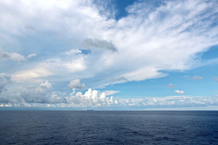 Seascapes. Various kinds of colorful blue sky, sun, clouds and open spaces of the world ocean. View from the side of the sea ship while moving and in the port at anchor.の写真素材