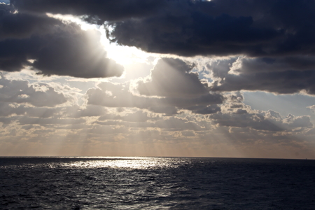 Seascapes. Various kinds of colorful blue sky, sun, clouds and open spaces of the world ocean. View from the side of the sea ship while moving and in the port at anchor.の写真素材