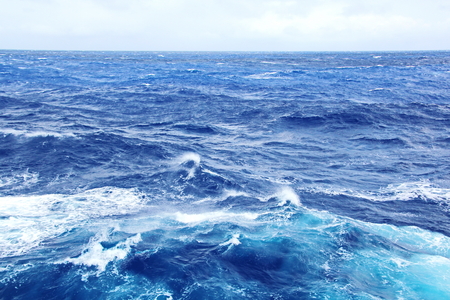 Storm waves in the world ocean. Kind of waves, crests, splashes, foam against the background of the...