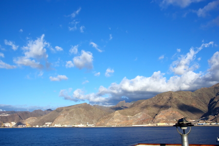 Colorful view of the coast of the Canary Islands and the port of Las Palmas against the blue sky and clouds from the side of the sea ship anchored. February, 2012.の写真素材