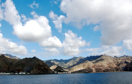 Colorful view of the coast of the Canary Islands and the port of Las Palmas against the blue sky and clouds from the side of the sea ship anchored. February, 2012.の写真素材