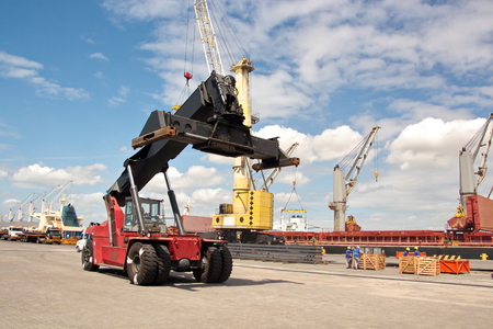 Transshipment terminal for loading steel products to sea vessels using shore cranes and special...