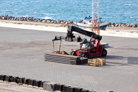 Transshipment terminal for loading steel products to sea vessels using shore cranes and special...
