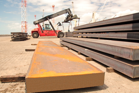 Transshipment terminal for loading steel products to sea vessels using shore cranes and special...