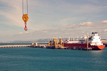 Transshipment terminal for loading steel products to sea vessels using shore cranes and special equipment. Vessels moored at berths and anchored in the roadstead. Sea and coastal line. Port Pecem, Brazil, June, 2017.の写真素材