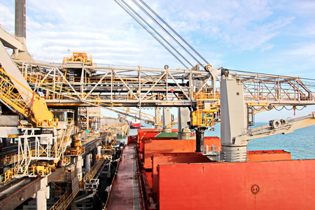 Loading terminal of coal products for cargo ships, bulkers and view of the cargo cranes loader and...