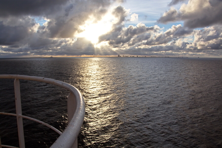 Panoramic views of the coast of the city of Brownsville, USA in the daytime and in the evening in the red rays of sunset. June, 2018. Observation from the side of the vessel in the roadstead.の写真素材