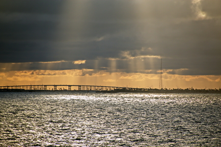Panoramic views of the coast of the city of Brownsville, USA in the daytime and in the evening in the red rays of sunset. June, 2018. Observation from the side of the vessel in the roadstead.の写真素材