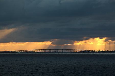 Panoramic views of the coast of the city of Brownsville, USA in the daytime and in the evening in the red rays of sunset. June, 2018. Observation from the side of the vessel in the roadstead.の写真素材
