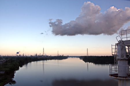 Panoramic views of the embankment and coastline on the river in the daytime and evening time against the blue sky, clouds and in the rays of sunset. View of the river Neches. Port Beaumont, Texas, USA. July 2017.の写真素材