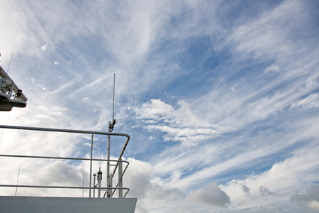 Ship structures, masts, antennas, funnel, ship wheelhouse against the blue sky and clouds.の写真素材