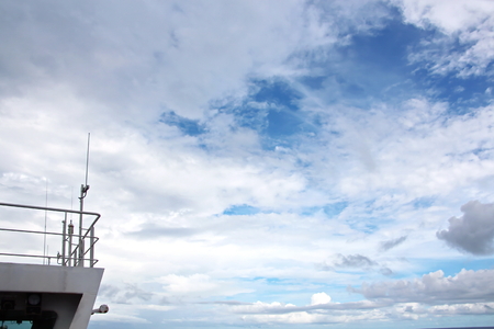 Ship structures, masts, antennas, funnel, ship wheelhouse against the blue sky and clouds.の写真素材