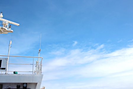Ship structures, masts, antennas, funnel, ship wheelhouse against the blue sky and clouds.の写真素材