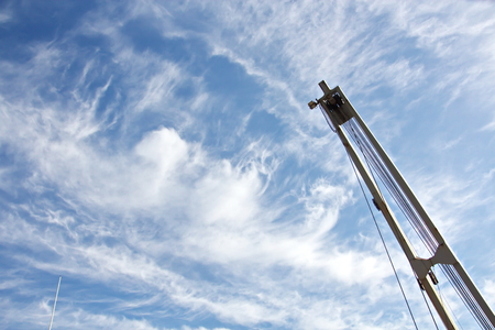 Ship structures, masts, antennas, funnel, ship wheelhouse against the blue sky and clouds.の写真素材