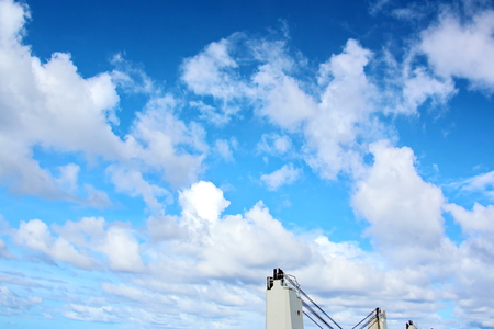 Ship structures, masts, antennas, funnel, ship wheelhouse against the blue sky and clouds.の写真素材