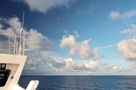 Ship structures, masts, antennas, funnel, ship wheelhouse against the blue sky and clouds.の写真素材