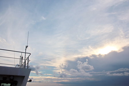 Ship structures, masts, antennas, funnel, ship wheelhouse against the blue sky and clouds.の写真素材