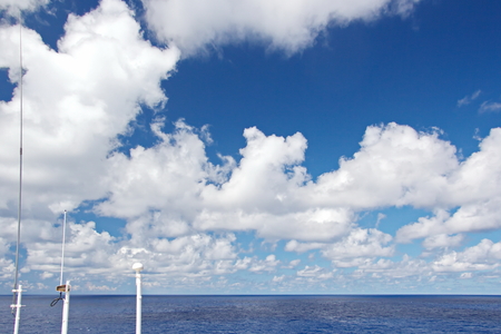 Ship structures, masts, antennas, funnel, ship wheelhouse against the blue sky and clouds.の写真素材