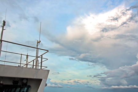 Ship structures, masts, antennas, funnel, ship wheelhouse against the blue sky and clouds.の写真素材