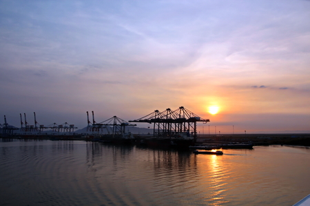 Container Terminal and vessels underway. Saigon Port, Vietnam. View of the terminal and cranes at sunrise.の写真素材